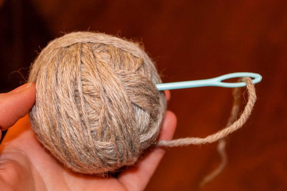 ball of yarn with knitting needle stuck into the side