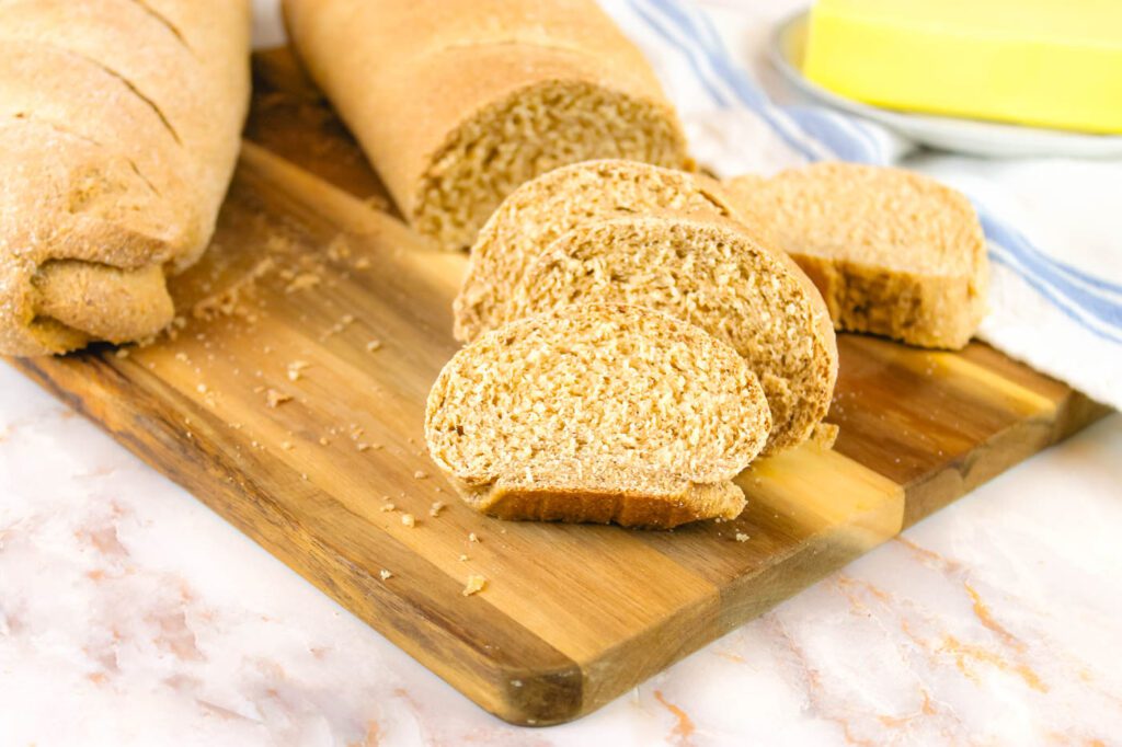 sliced bread on a wooden cutting board in the kitchen