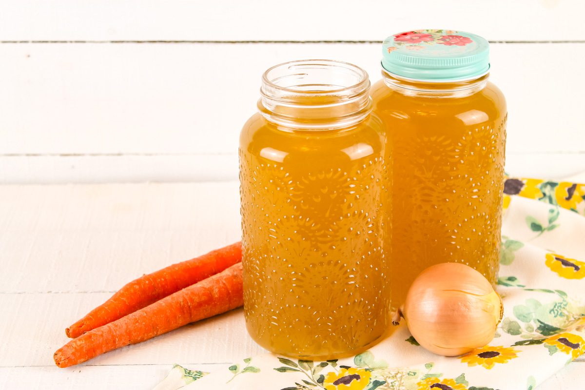 two glass jars full of bone broth in the instant pot