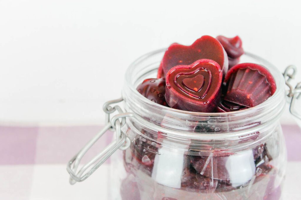 jar of purple colored homemade fruit snacks sitting in the kitchen