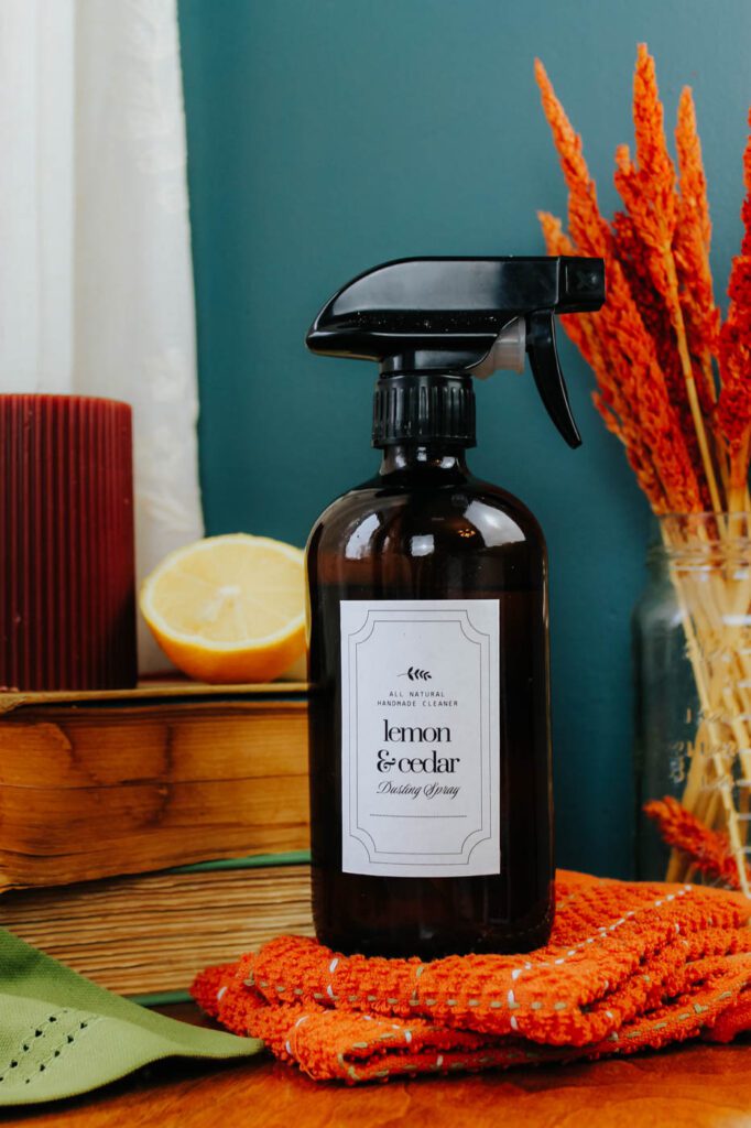 amber color spray bottle filled with cleaning fluid sits on a bay window