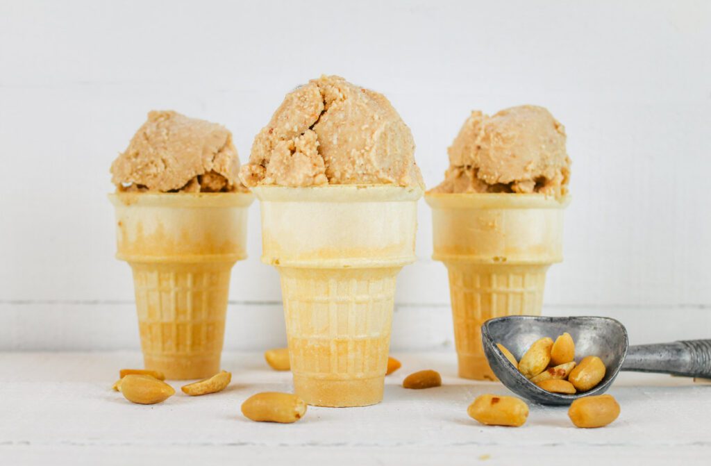 3 ice cream cones with homemade peanut butter ice cream on a white countertop