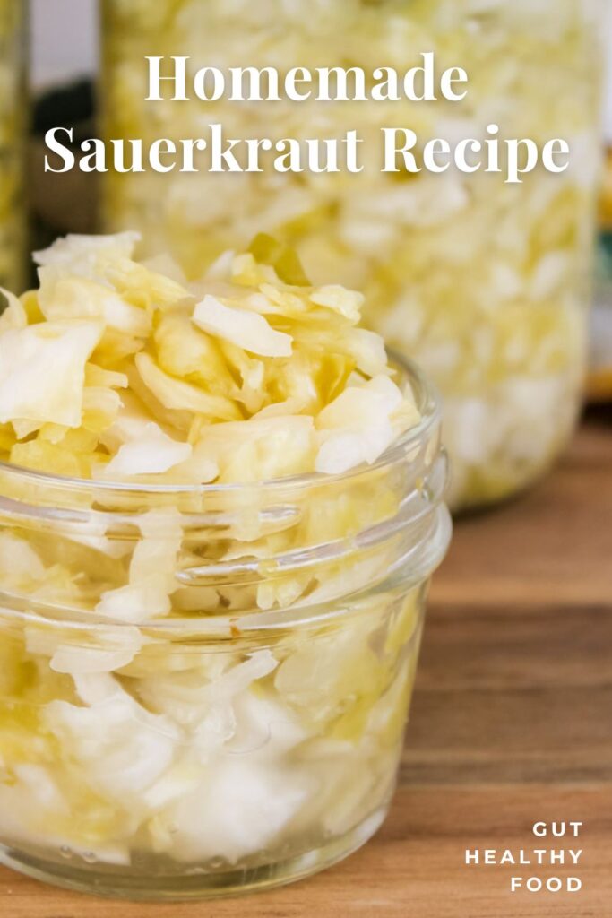 a wooden countertop displays a couple jars of homemade sauerkraut