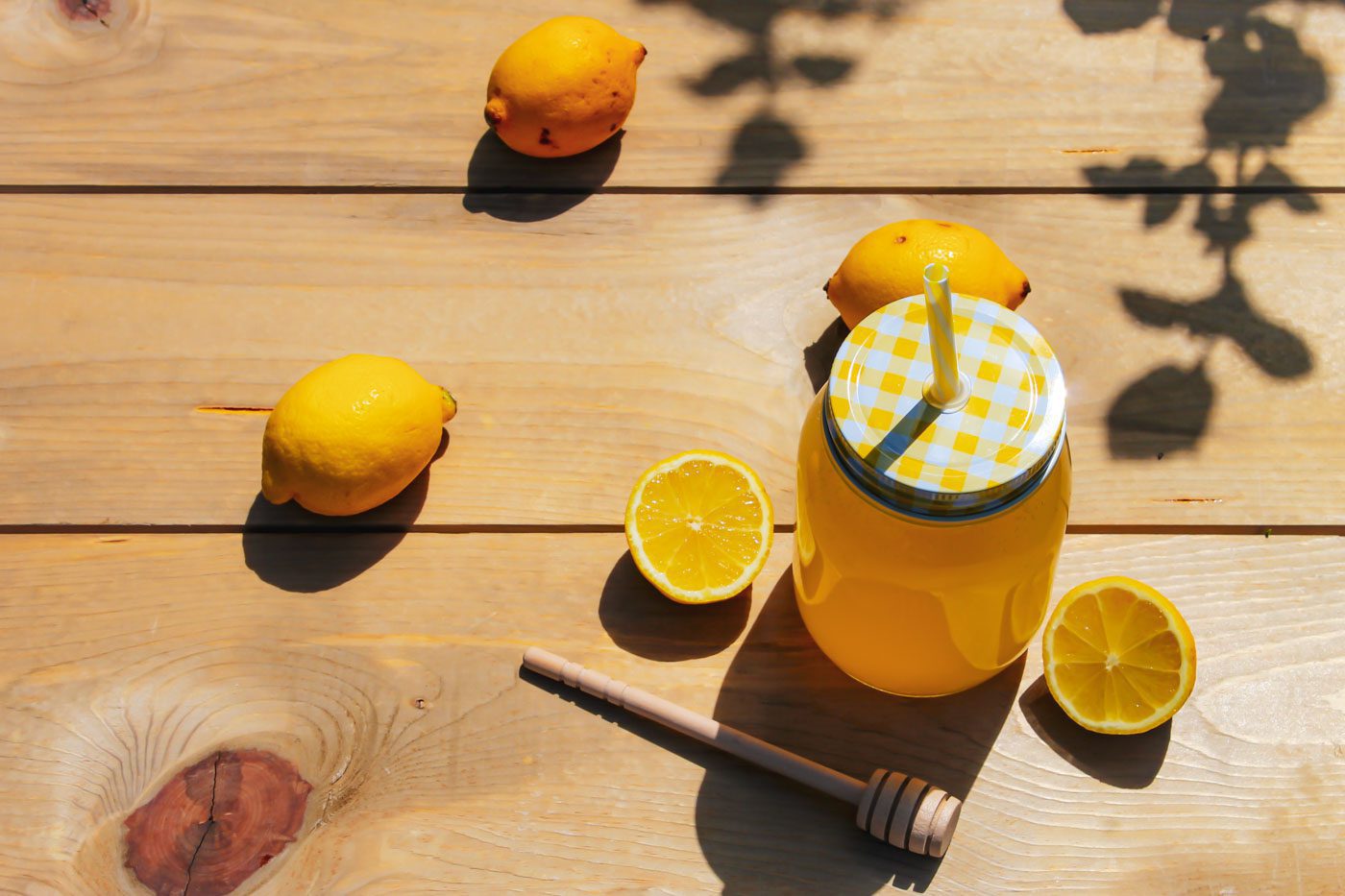 top view of sliced lemons and mason jar full of lemonade