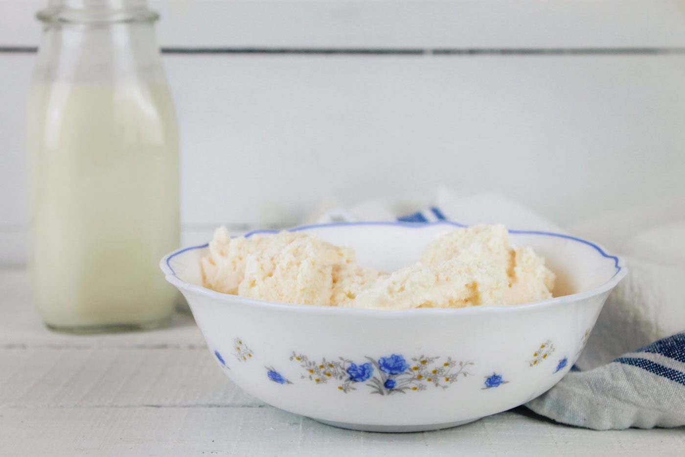 blue and white floral bowl full of homemade ice cream using raw milk