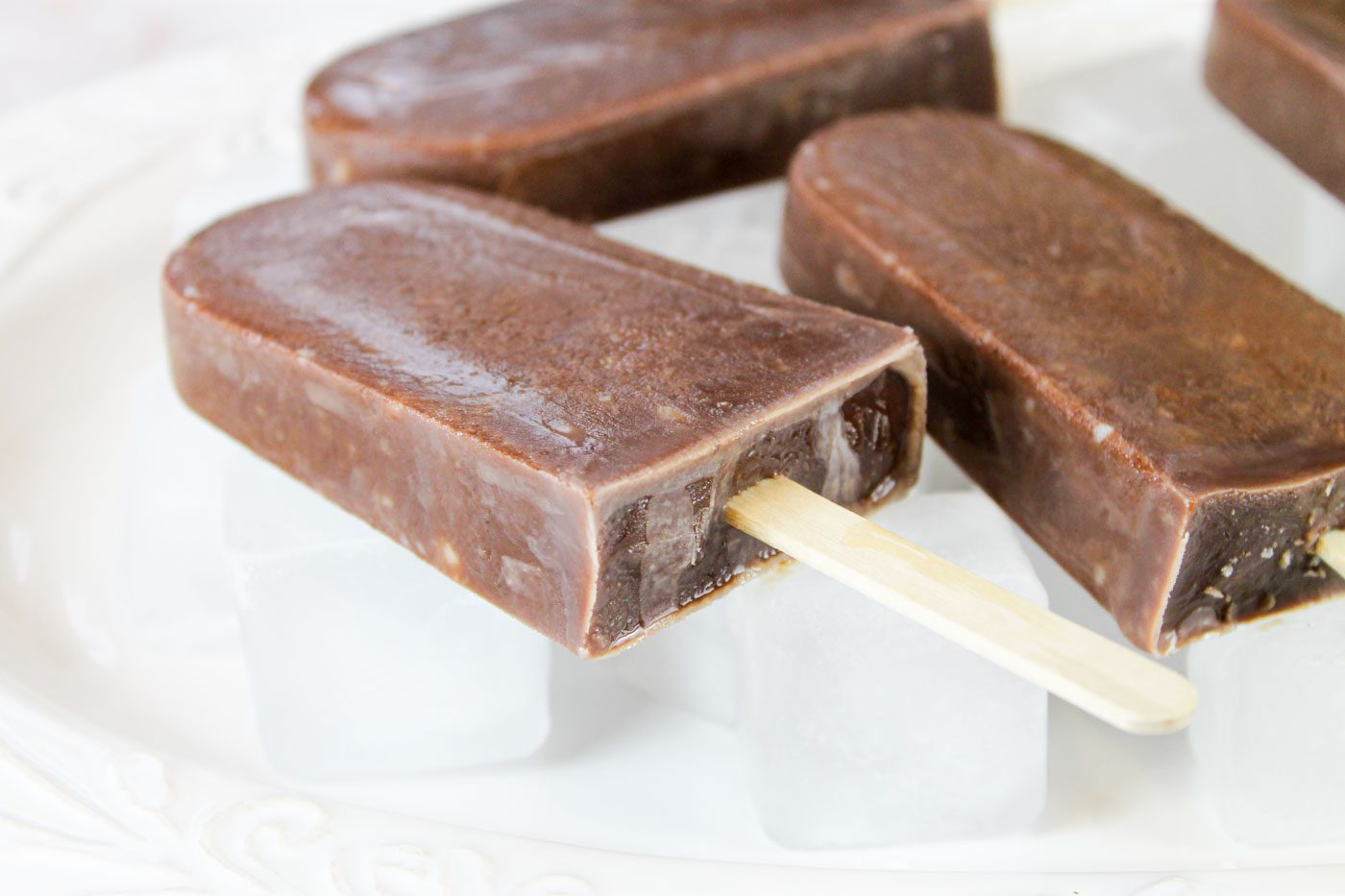 3 fudge pops sit on a bed of ice cubes