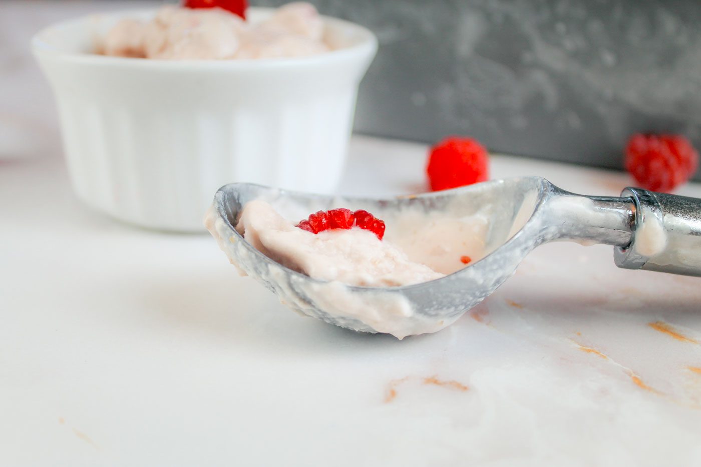 ice cream scoop full of melted raspberry ice cream