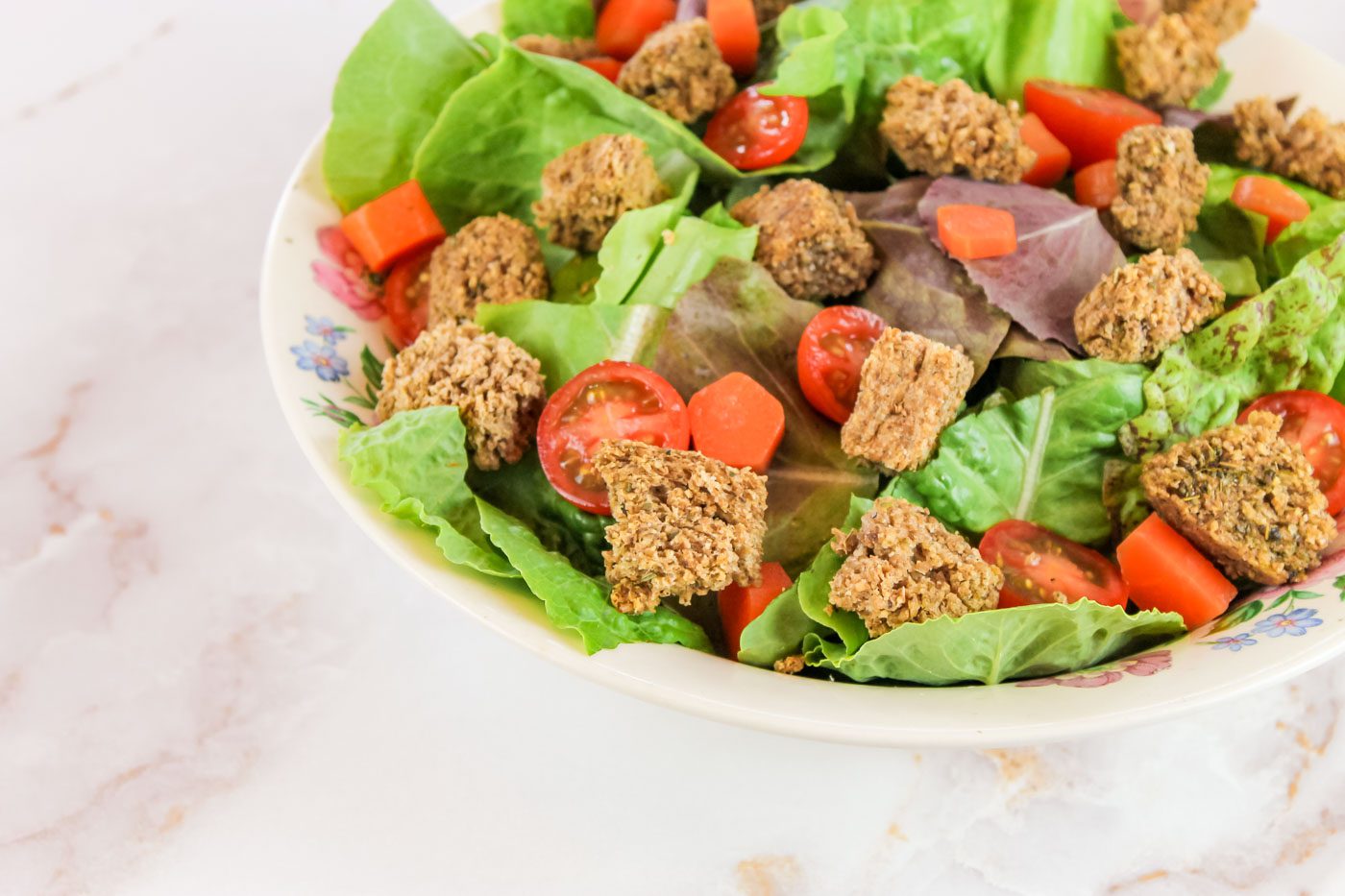 fresh salad topped with croutons