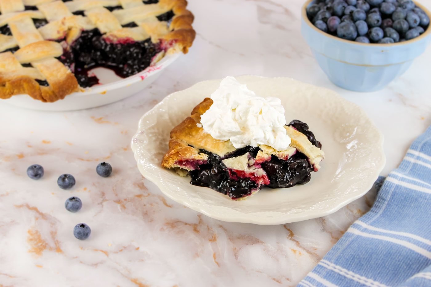 slice of blueberry pie with whipped cream