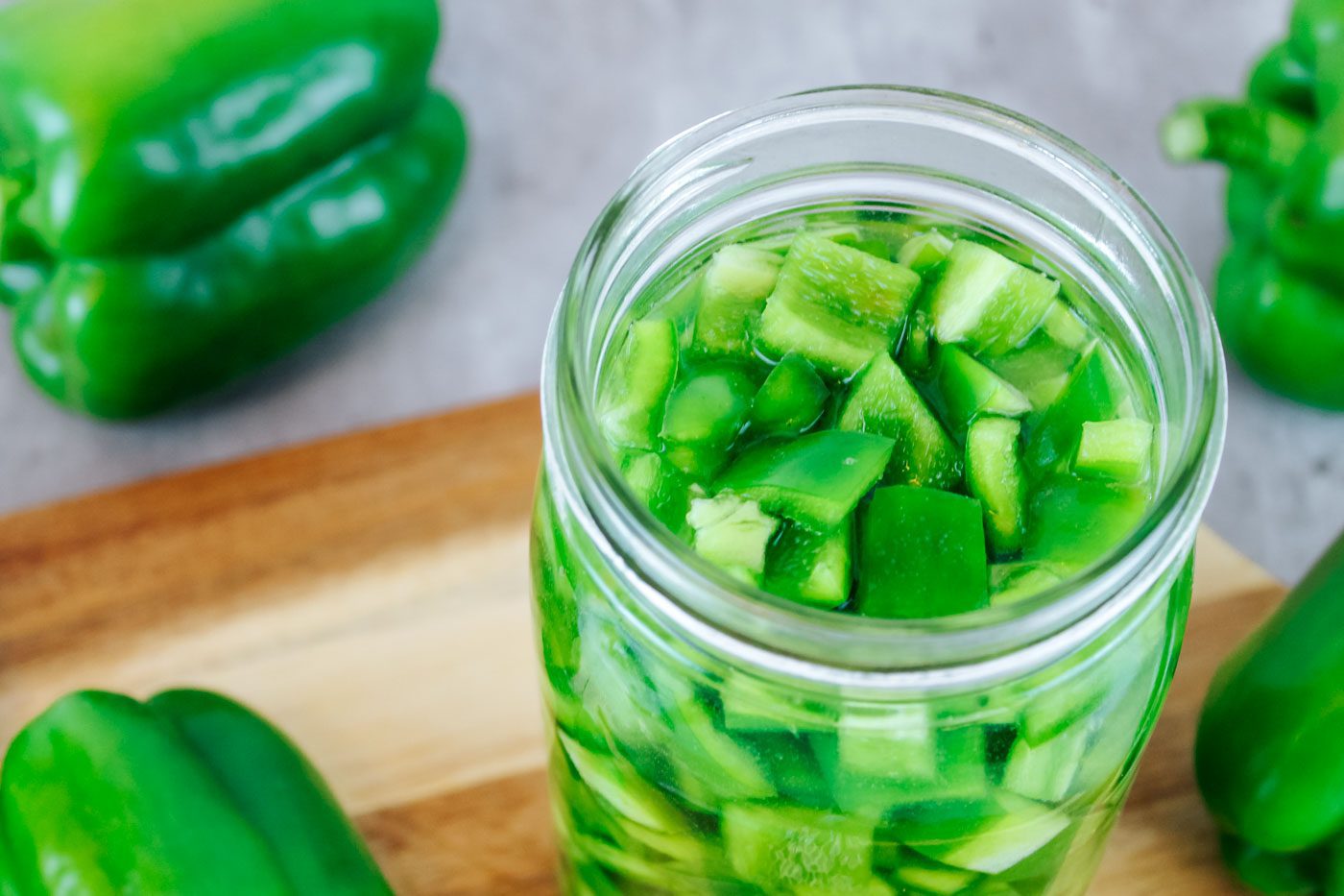 top view of glass mason jar with diced green peppers inside