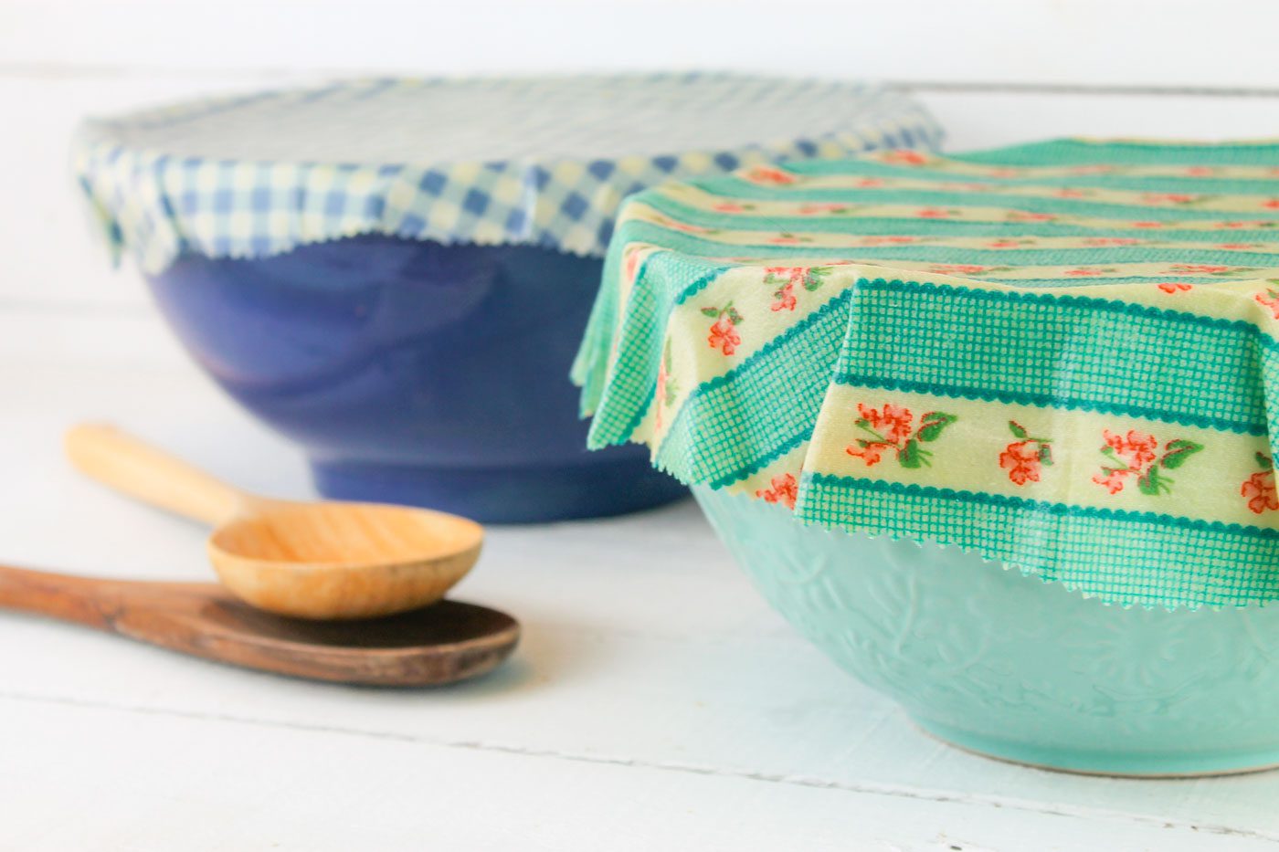 two glass mixing bowls covered with sheets of beeswax wraps