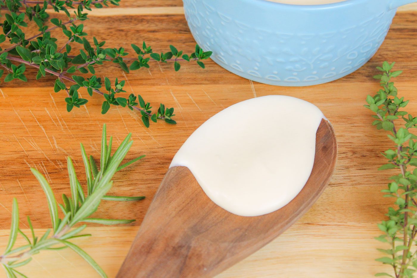 wooden spoon full of cream sitting on a cutting board