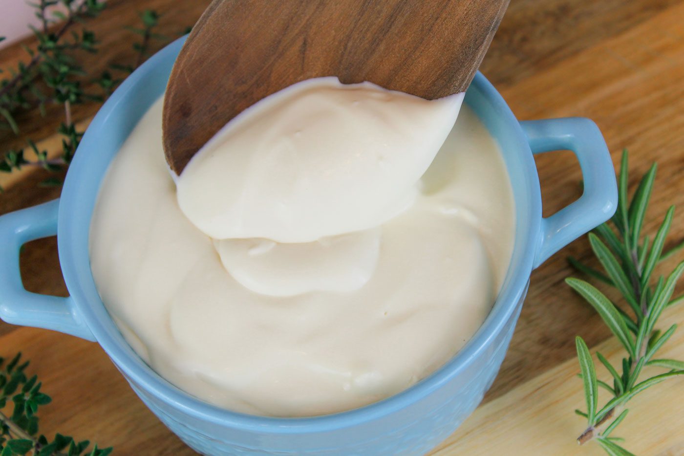 wooden spoon scoops up kefir sour cream