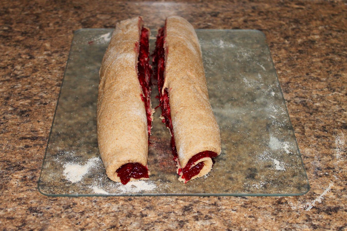 cranberry bread split into two pieces for braiding