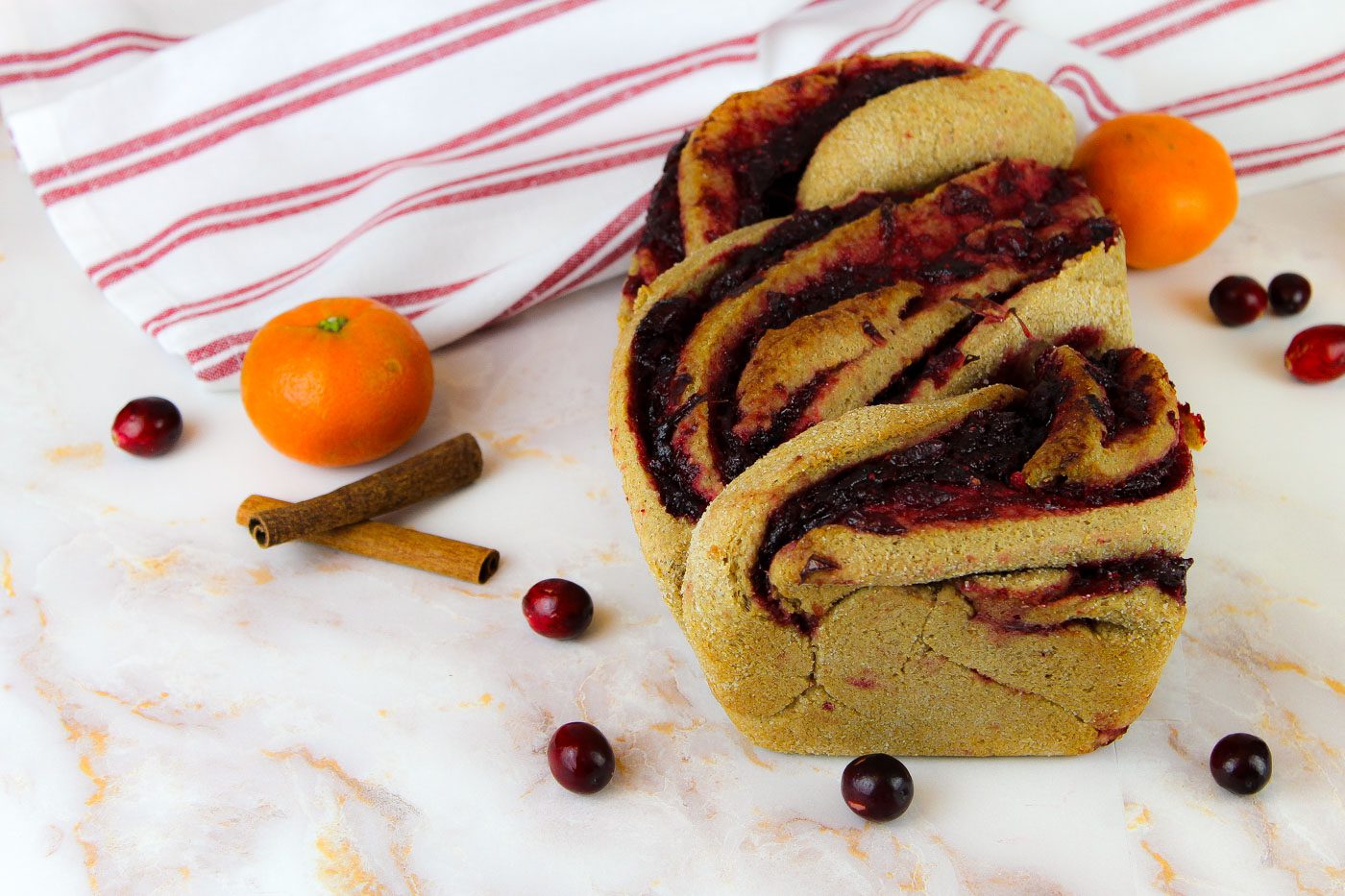 fresh milled flour bread with cranberry swirls sits on a marble countertop