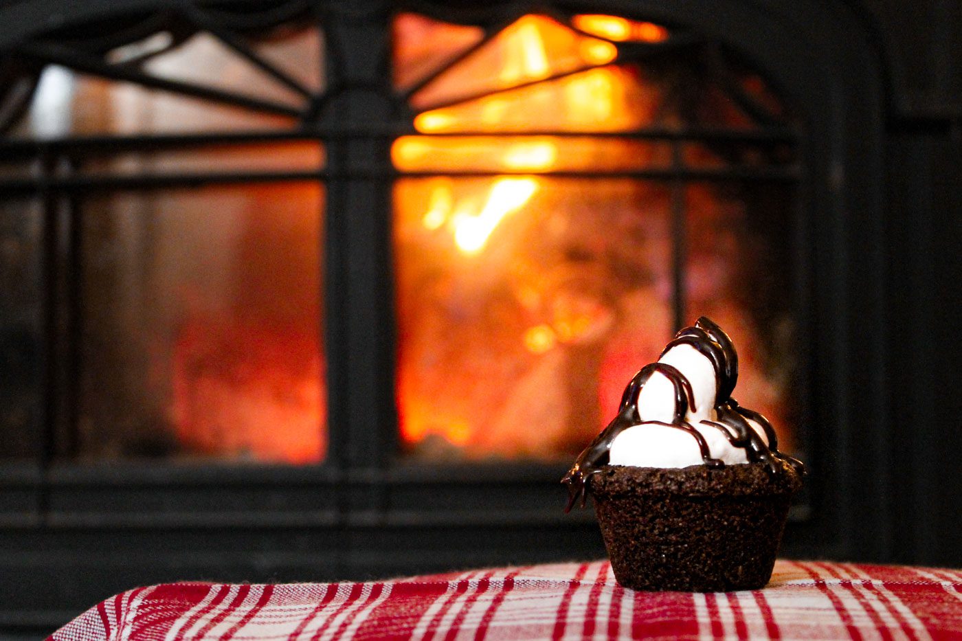 hot cocoa cookie sitting in front of a fireplace