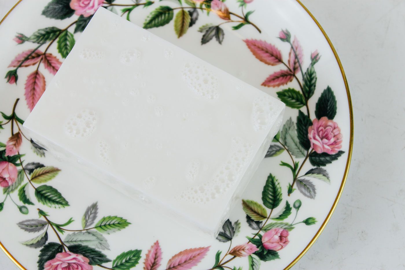 melt and pour shampoo bar sitting on a floral plate