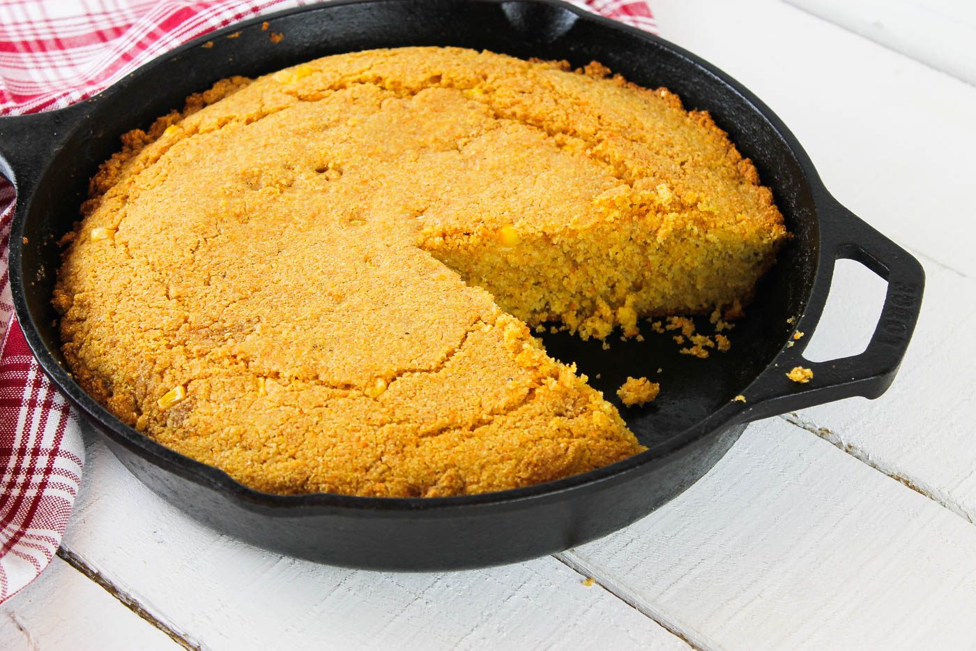 pan with a slice of cornbread cut out of it