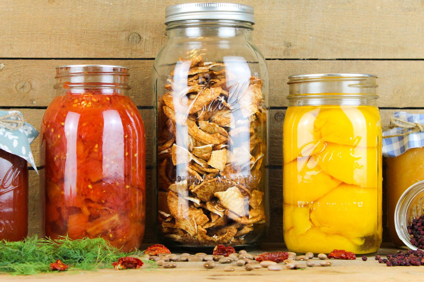 jars of home preserved food sitting on a wooden shelf