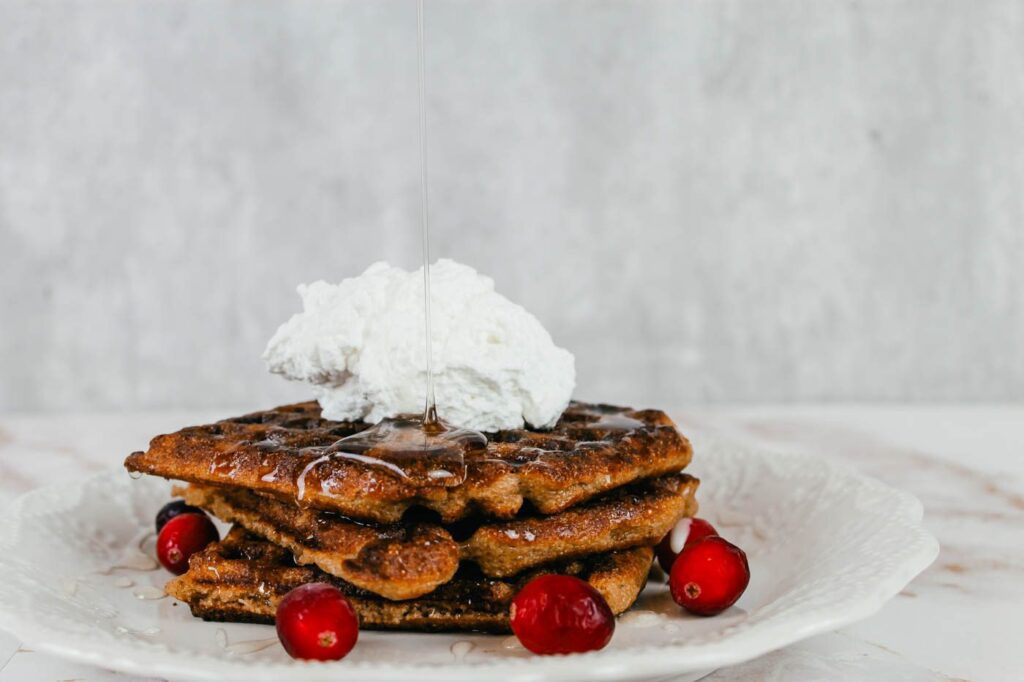 syrup pouring on top of a stack of gingerbread waffle recipe