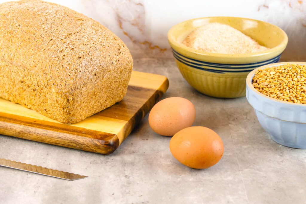 countertop filled with baked goods and baking supplies and a sandwich bread recipe