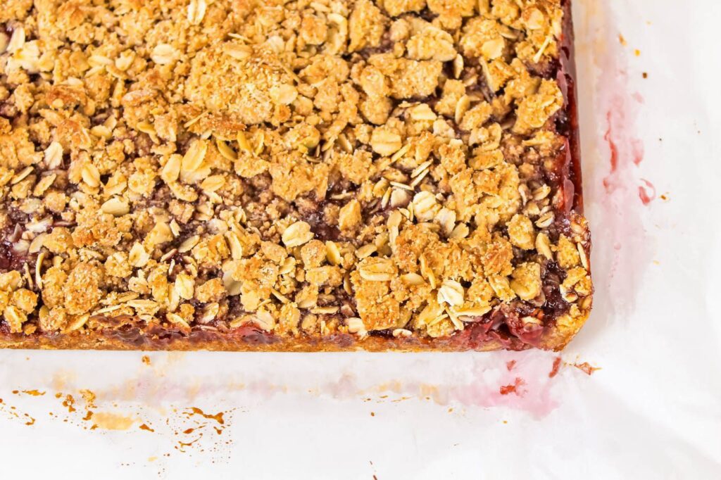 oat crumble snack sitting on a strained piece of parchment paper