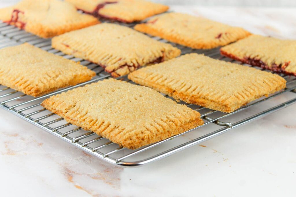 9 homemade pop tarts lay on a cooling rack