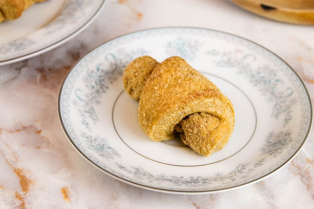 crescent roll sits on a blue floral plate