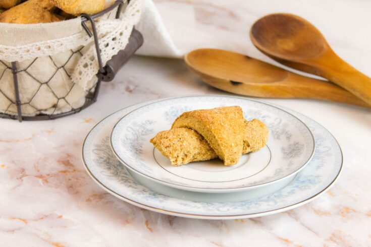 a fresh milled dinner roll sits on two blue and white plates