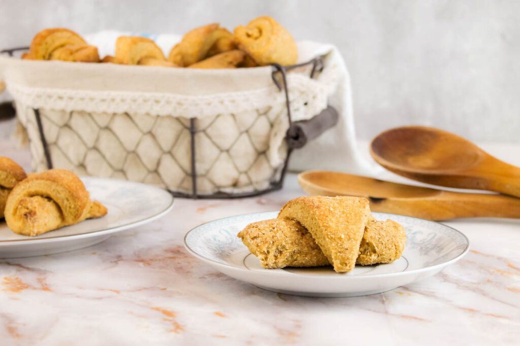 plates and baskets filled with no knead dinner rolls with fresh milled flour