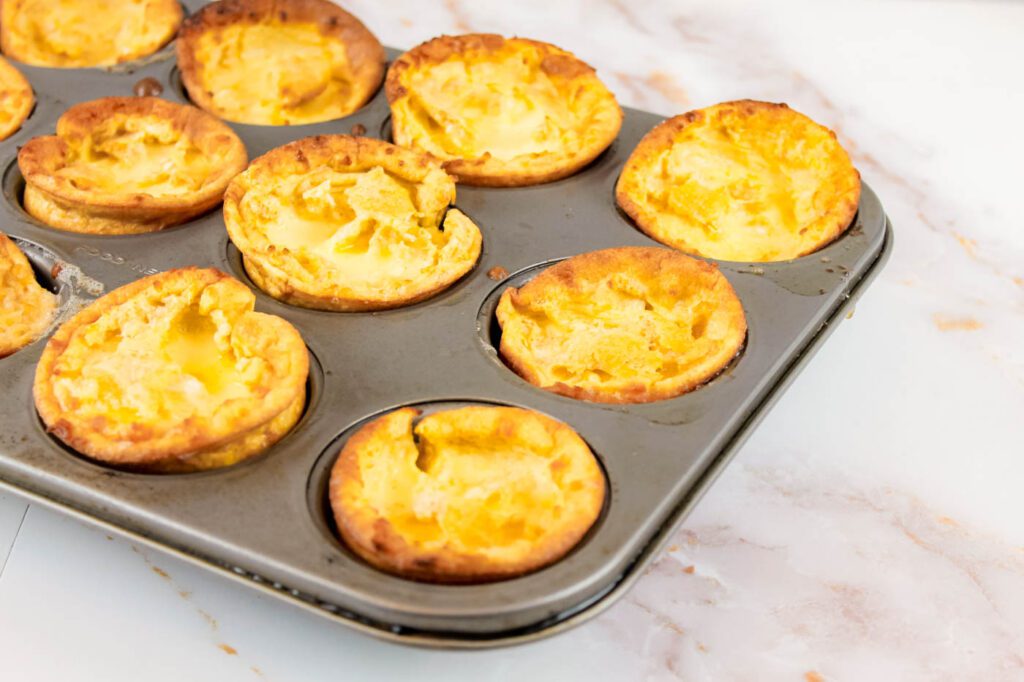 a muffin tray filled with puff pancakes