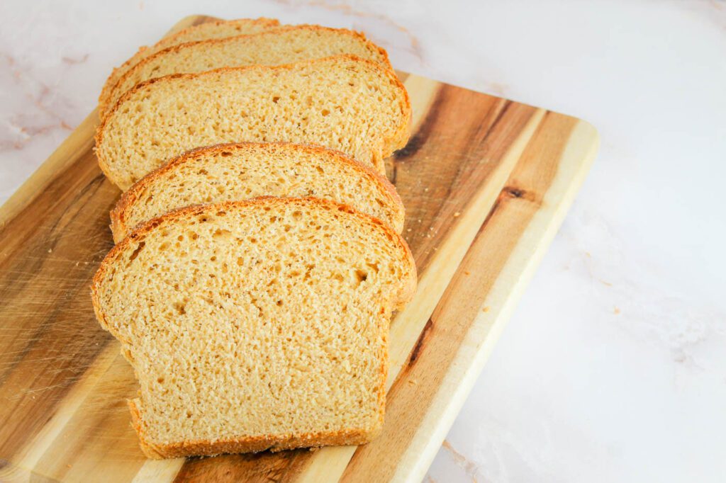 slices of bread laid upon each other on a wooden cutting board