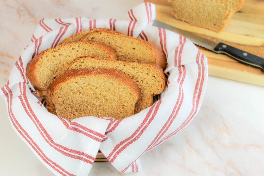 wooden basket filled with slices of whole grain potato bread