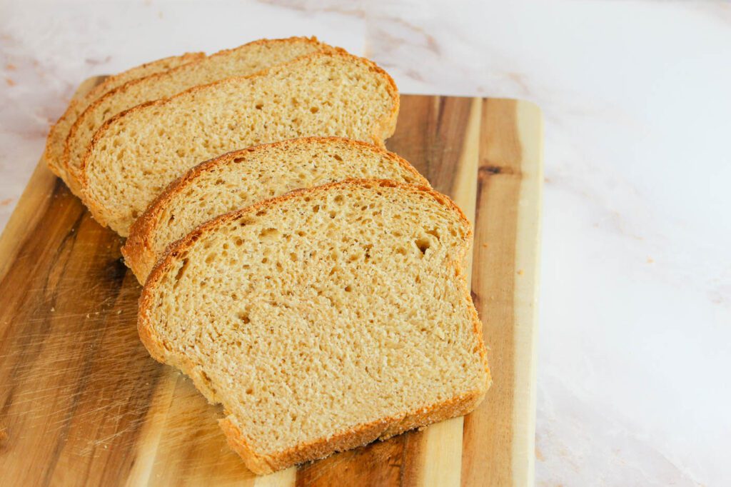 homemade potato bread sliced and stacked on top of each in a kitchen with a marble countertop