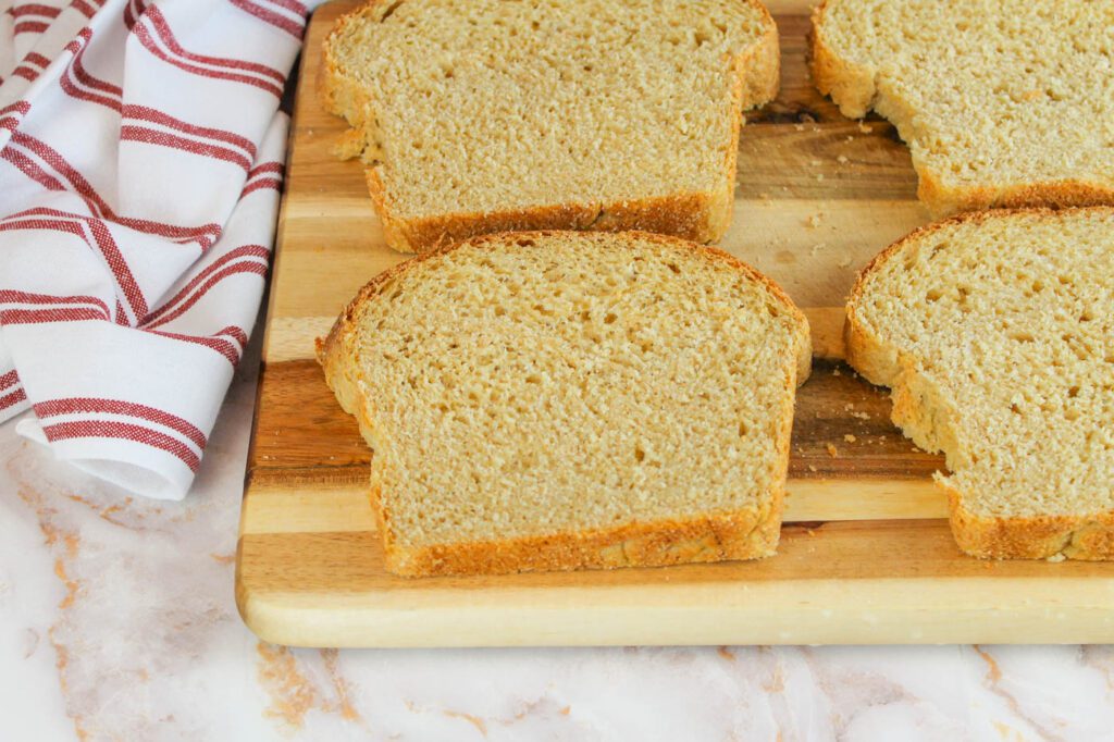 four slices of potato bread with fresh milled flour on a cutting board in a kitchen