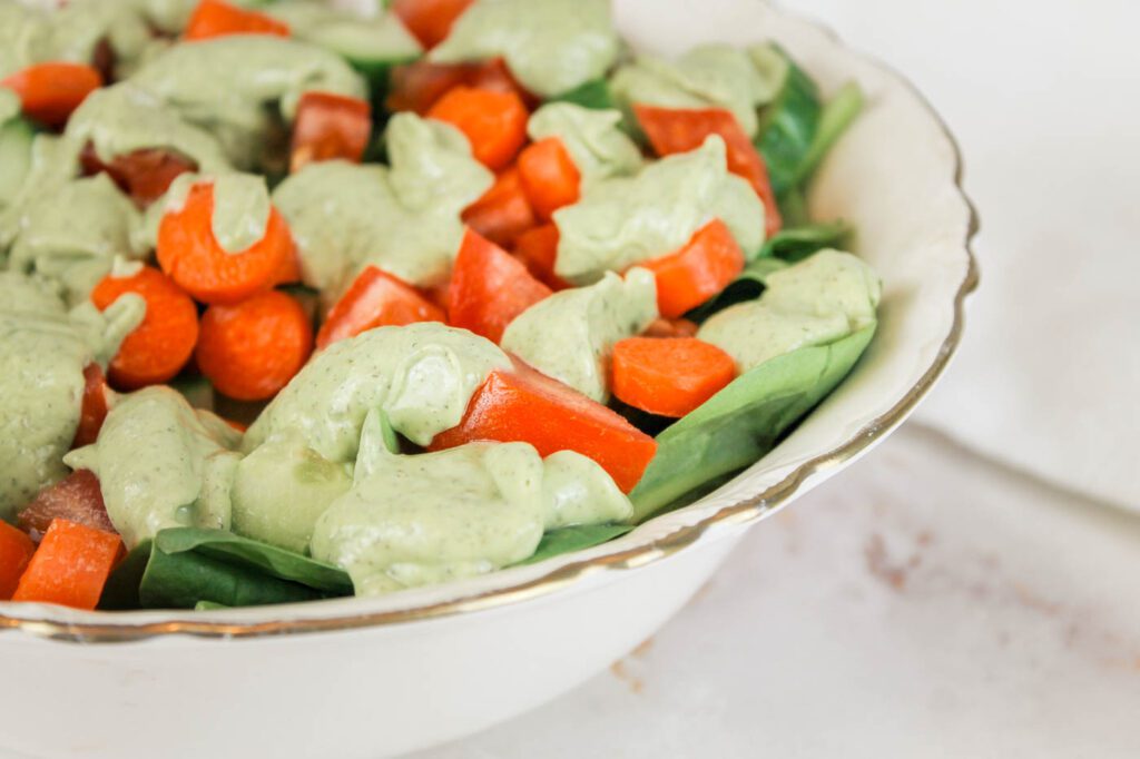 bowl of salad sitting on a marble kitchen countertop