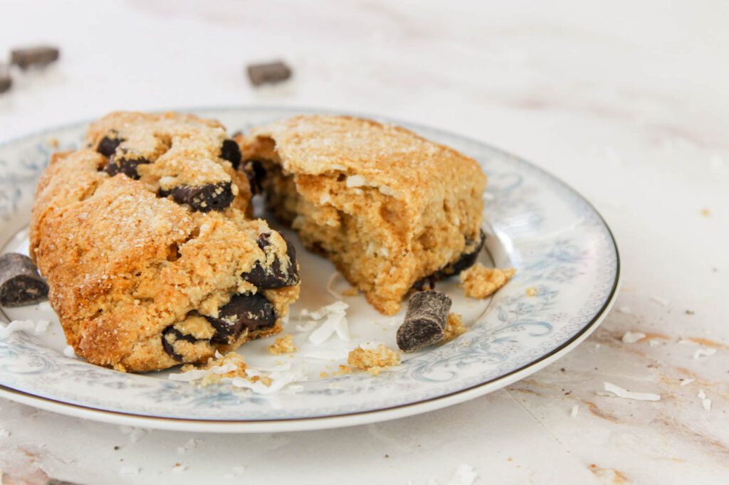 a scone broken in half, sitting on a plate reveals what the inside of the scone looks like