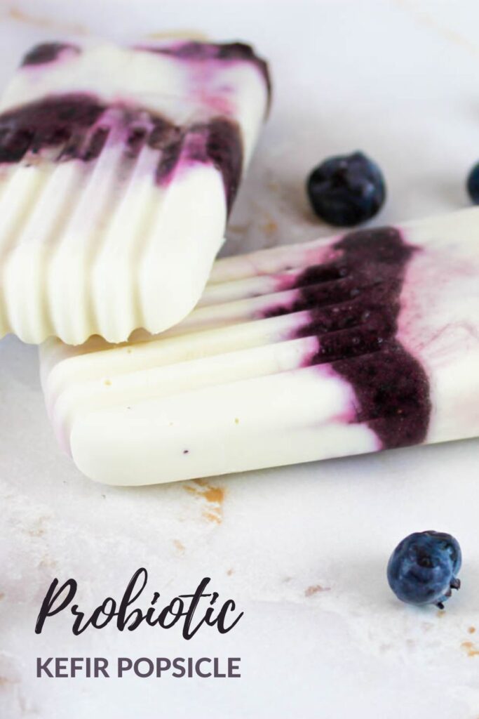 pinterest graphic showing two blueberry popsicles laying on top of each other