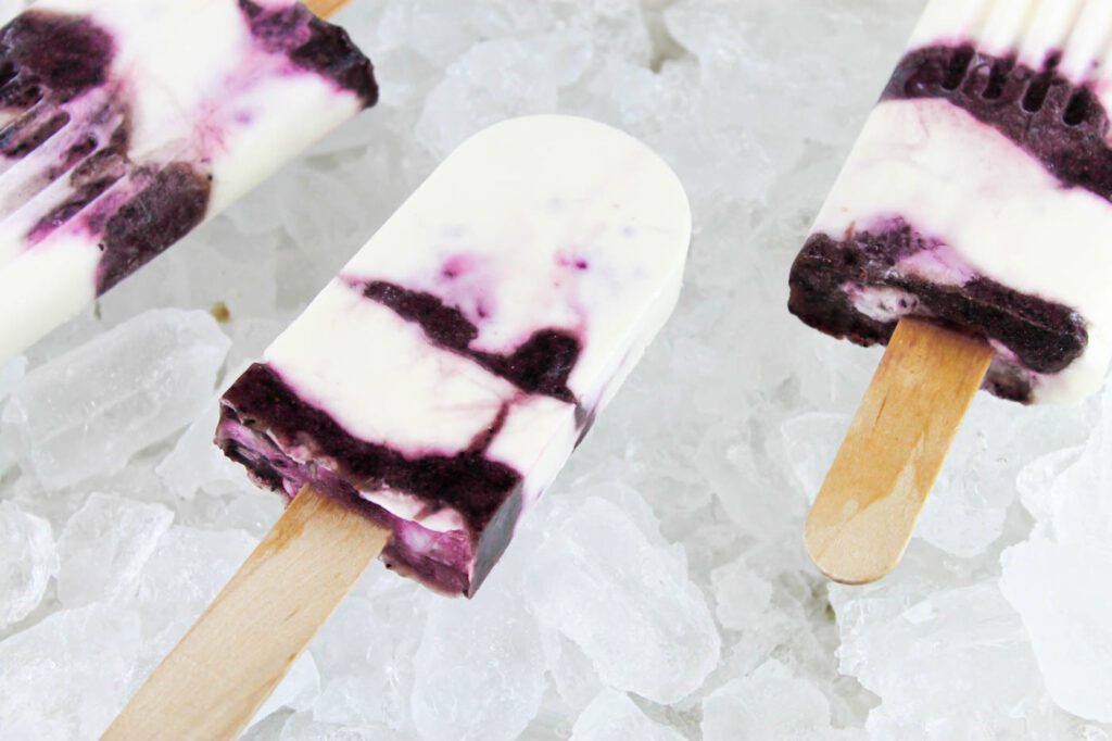 3 frozen desserts sitting in a tray of ice