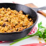 cast iron skillet filled with pan fried okra with fresh milled flour