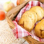 basket filled with apple hand pies next to a pile of fugi apples