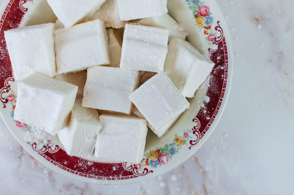 a red floral bowl filled with healthy homemade marshmallows