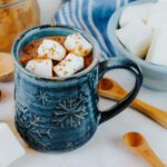 healthy hot chocolate recipe with raw milk in a blue snowflake cup
