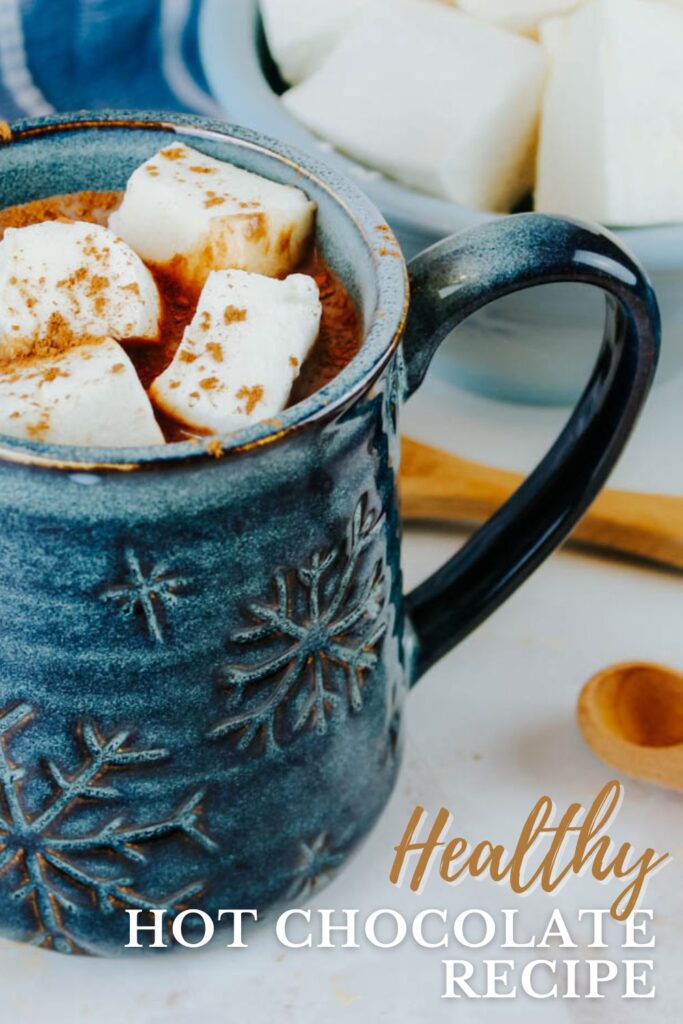 pinterest graphic showing a blue snowflake mug filled with warm chocolate milk
