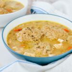 two blue and white bowls filled with chicken and dumplings with fresh milled flour