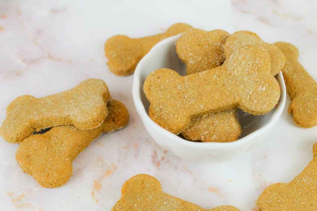 bowl of dog biscuits on a marble countertop