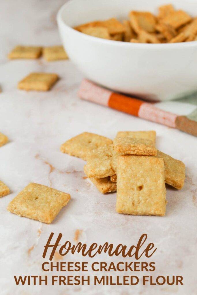 pile of crackers sitting in front of a white glass bowl
